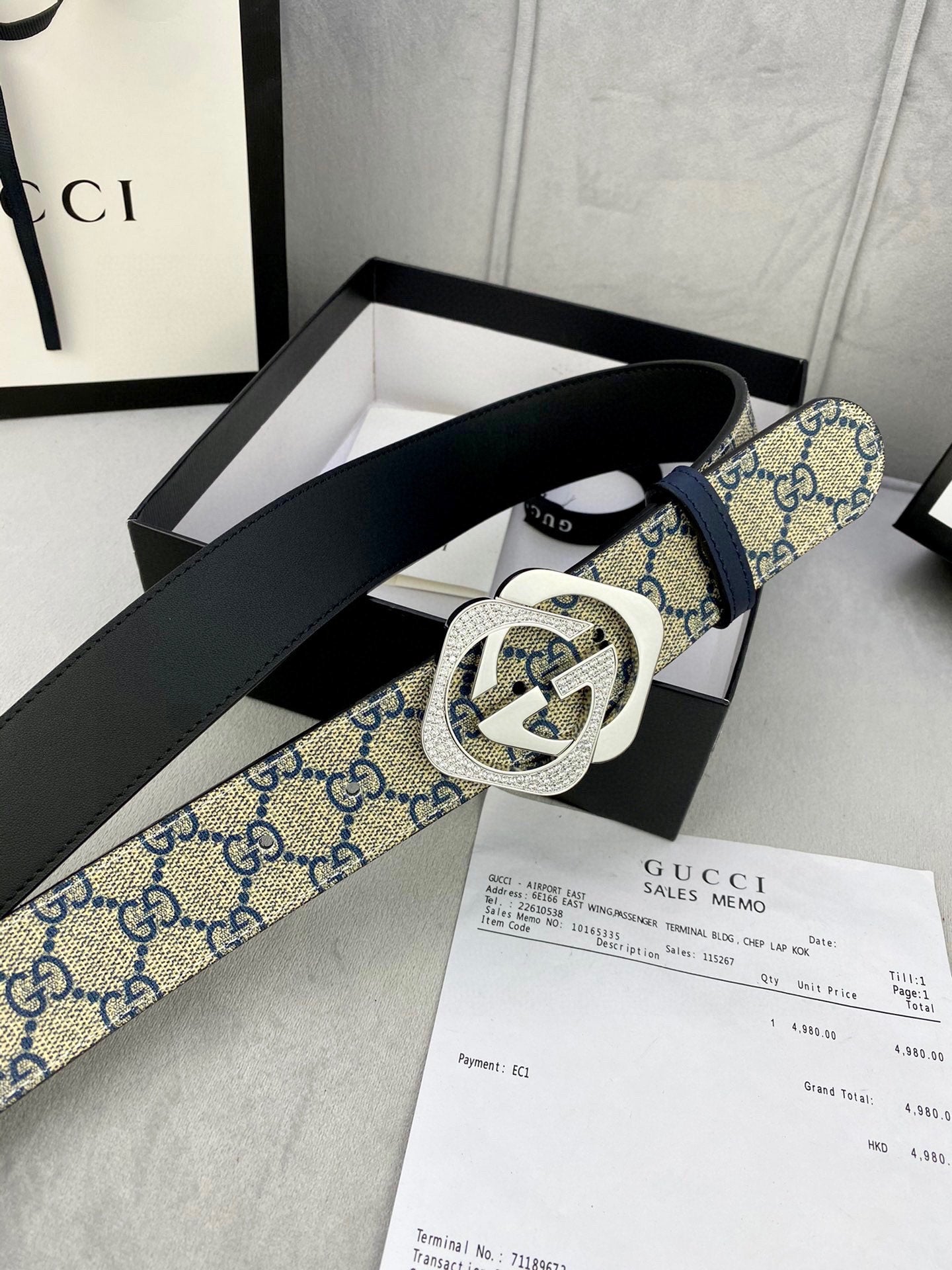 Designer belt with blue GG monogram strap, black leather reverse, gold-tone buckle