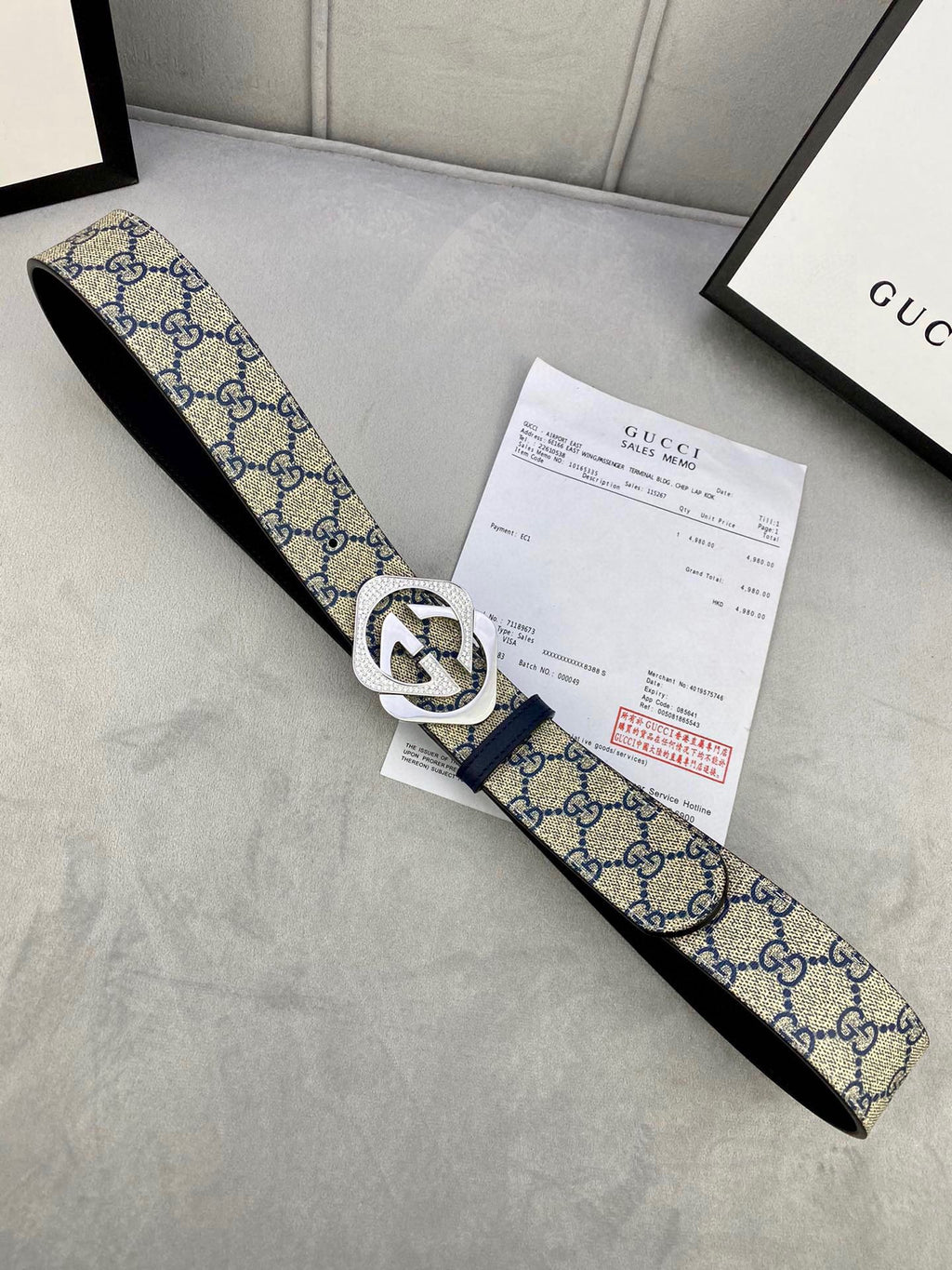 Canvas GG monogram belt with navy/blue strap, white edge trim, silver buckle
