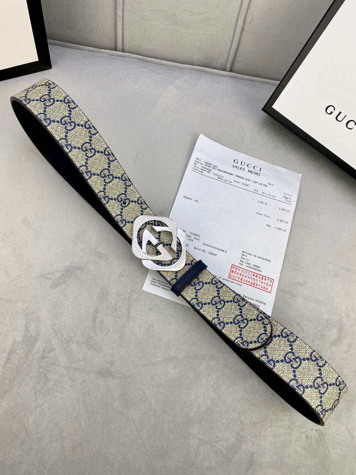 Canvas GG monogram belt with navy/blue strap, white edge trim, silver buckle