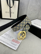GG monogram belt with navy strap and black leather side, featuring a gold-tone buckle