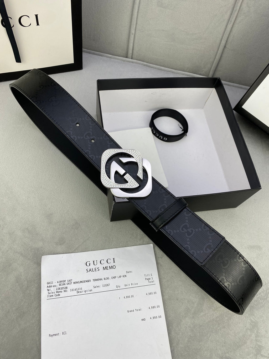 Gucci belt in dark leather with large silver interlocking buckle and pin holes.