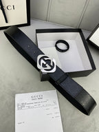 Gucci belt in dark leather with large silver interlocking buckle and pin holes.