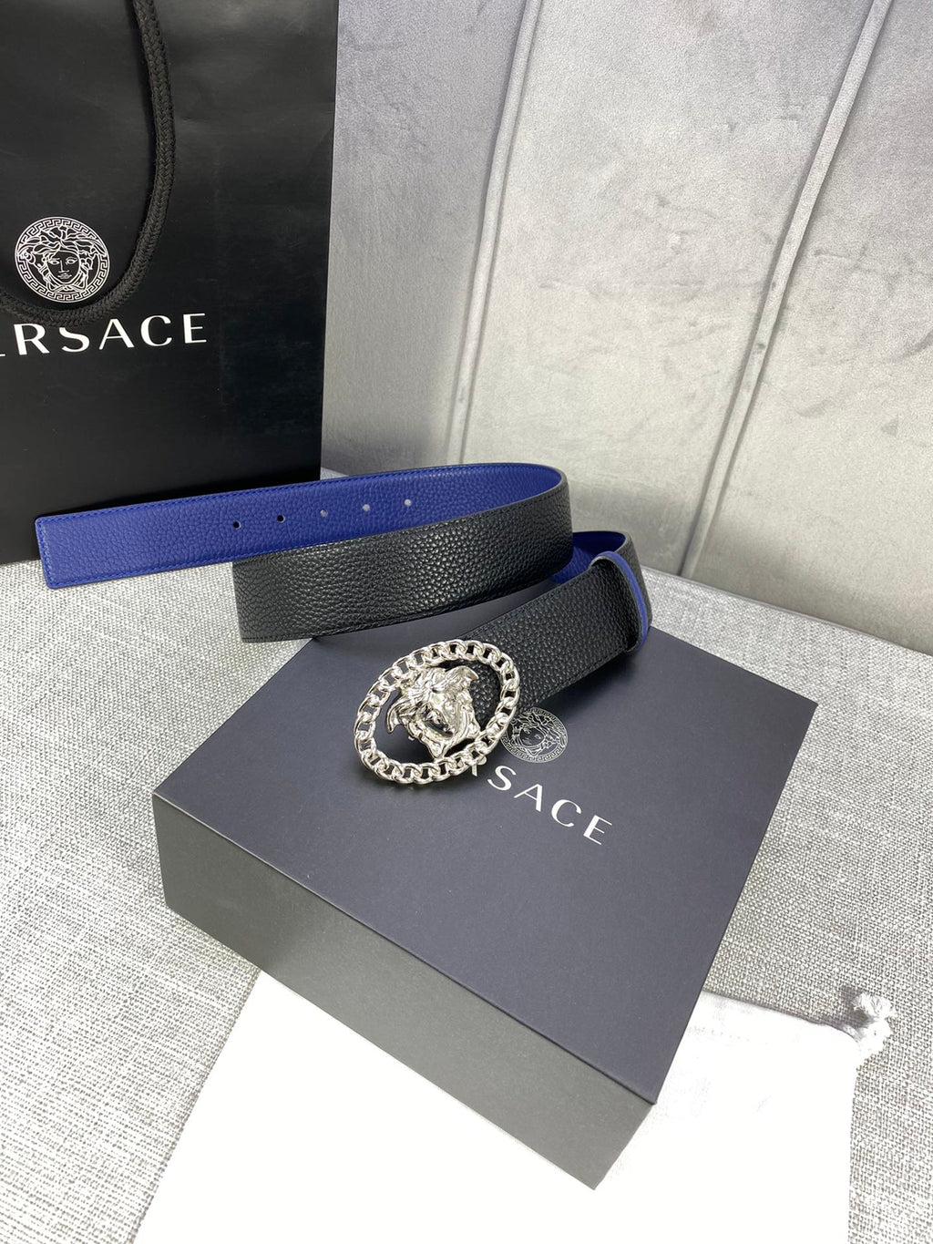 Leather belt with black and blue design, silver Medusa buckle