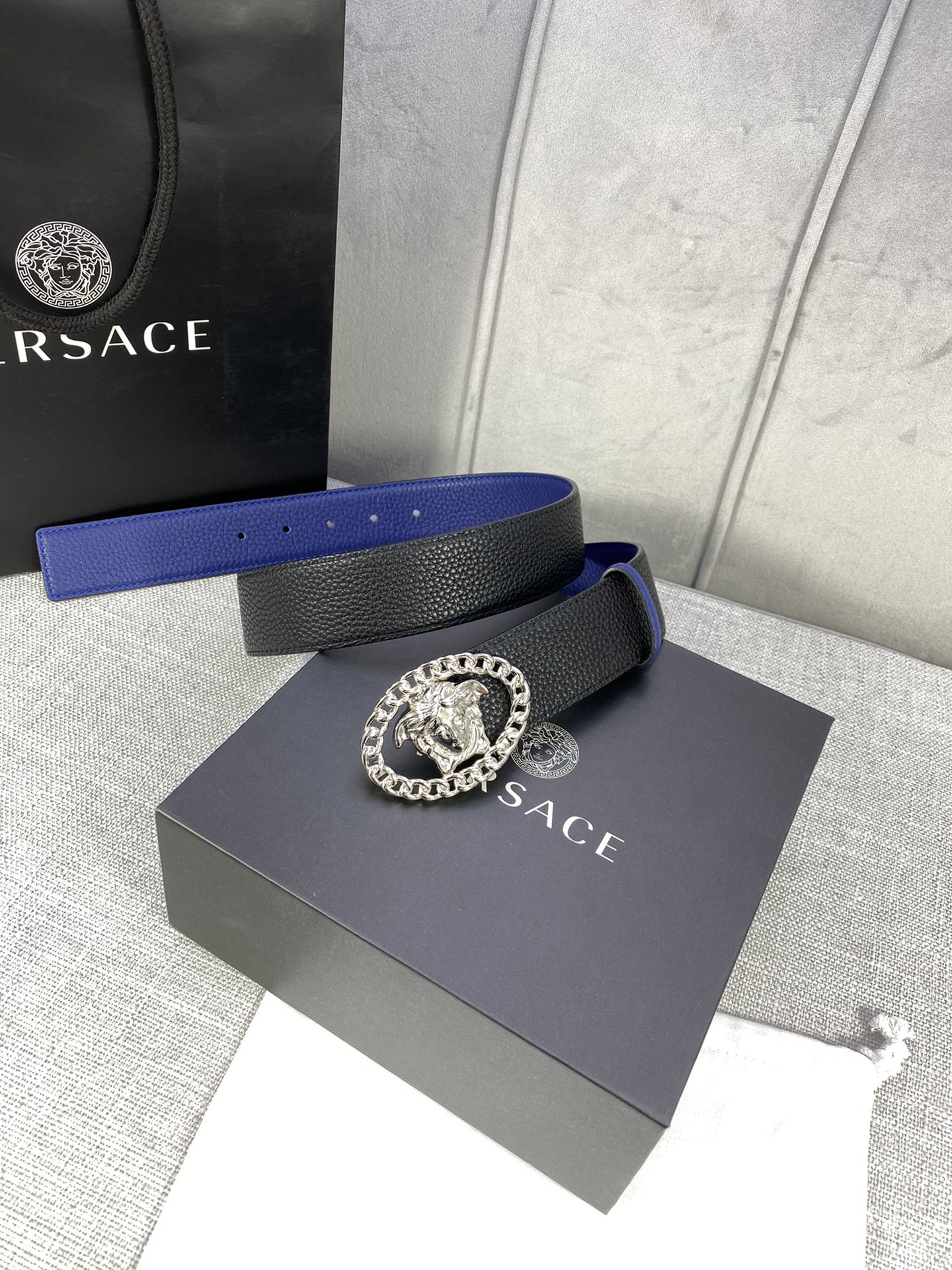 Leather belt with black and blue design, silver Medusa buckle