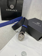 Leather belt with black textured strap, blue underside, silver Medusa buckle