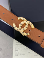 Chanel belt buckle close-up: tan-brown leather strap with gold CHANEL medallion