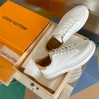Louis Vuitton white leather sneakers, side view with textured monogram details