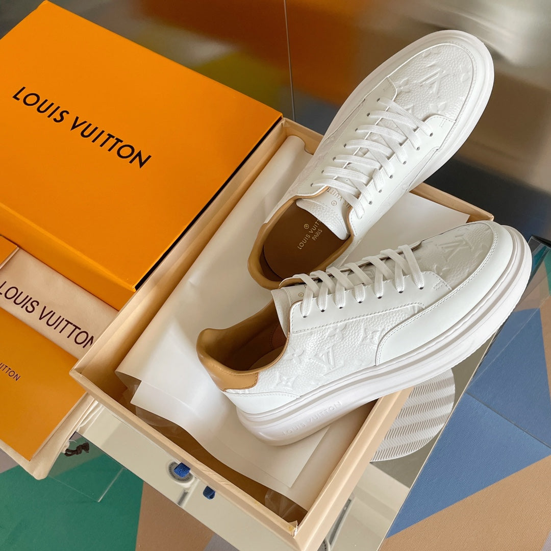 Louis Vuitton white leather sneakers, side view with textured monogram details
