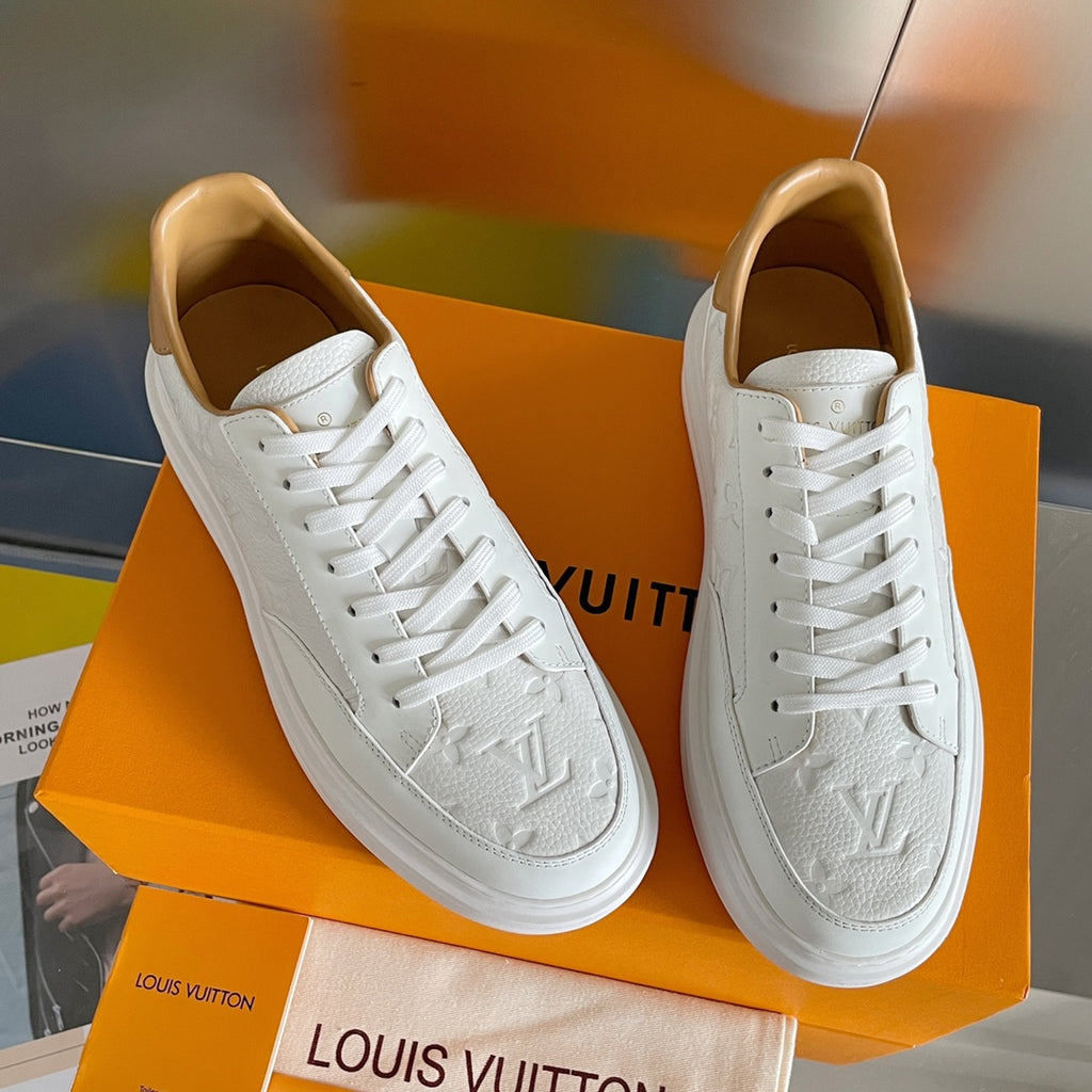 Louis Vuitton white leather sneakers, angled side view on orange shoebox