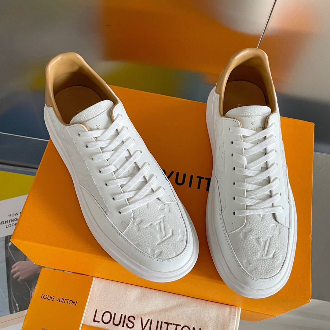 Louis Vuitton white leather sneakers, angled side view on orange shoebox