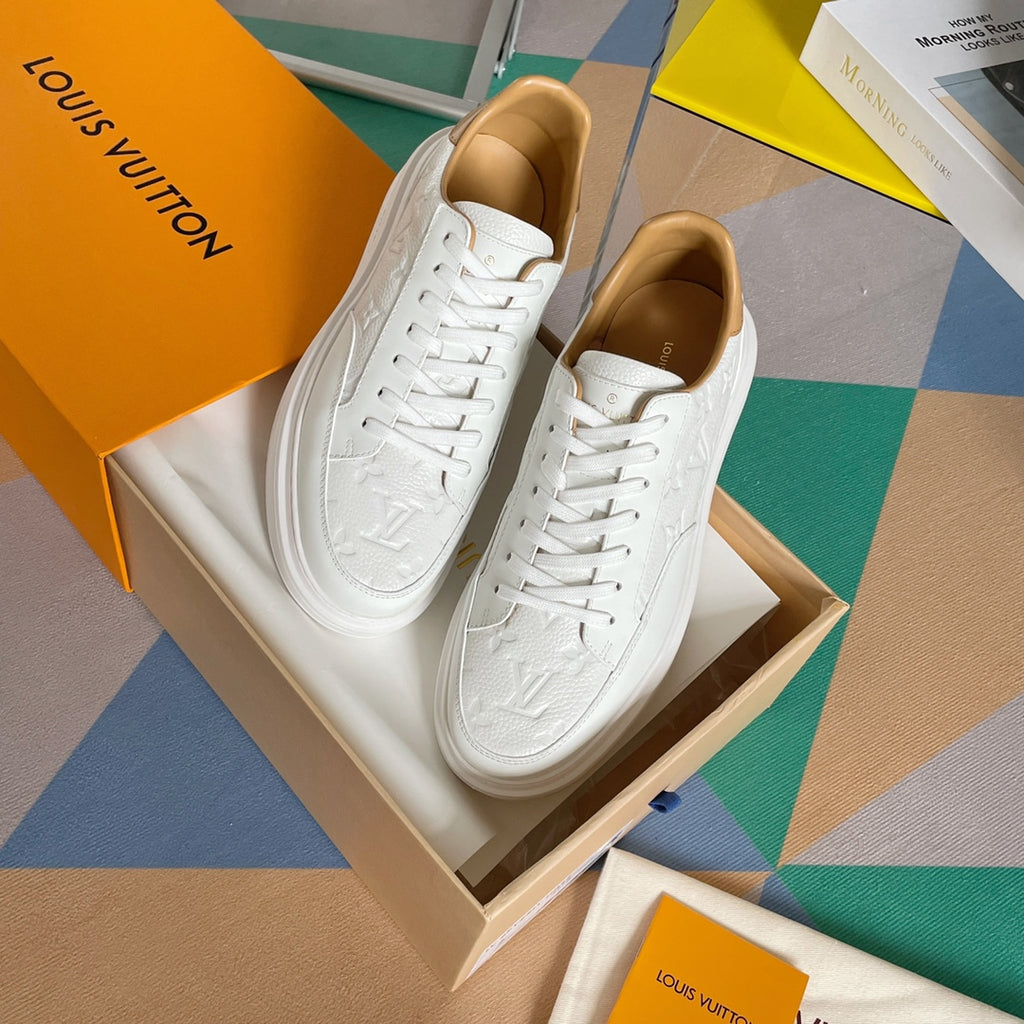 Louis Vuitton white lace-up sneakers, pair displayed on tan box with tan lining