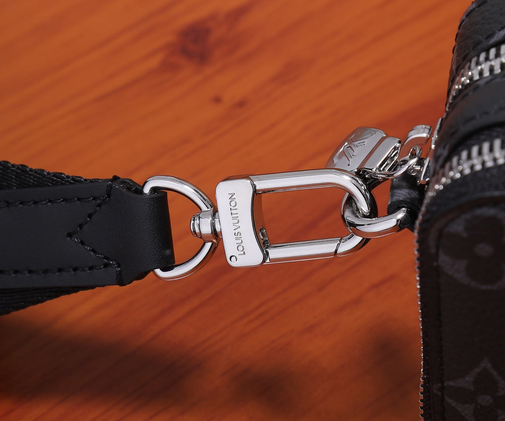 Louis Vuitton bag strap hardware with metal ring and lobster clasp on dark canvas