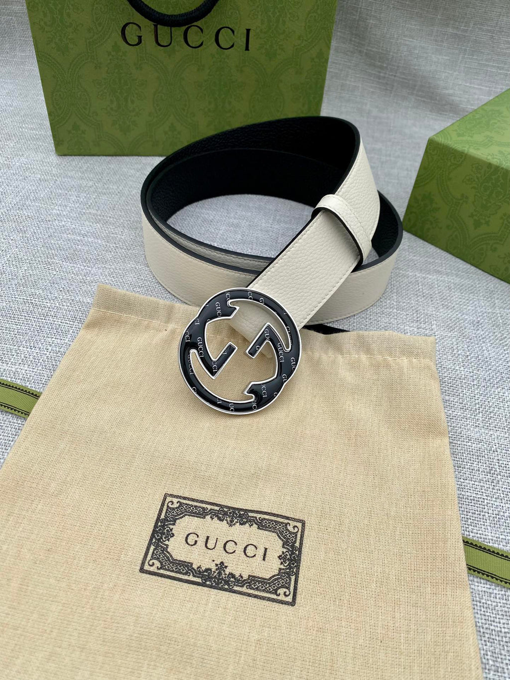 Gucci white leather belt with round black GG buckle and keeper holes