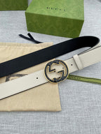 Gucci white leather belt with black GG logo buckle, belt end angled