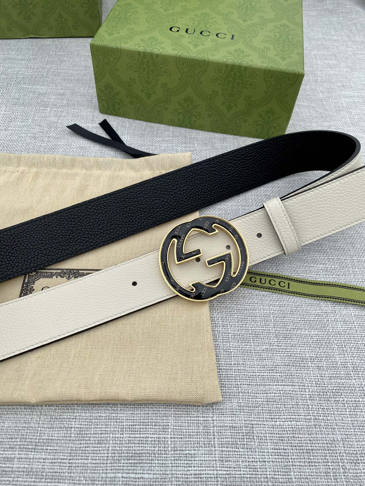 Gucci white leather belt with black GG logo buckle, belt end angled