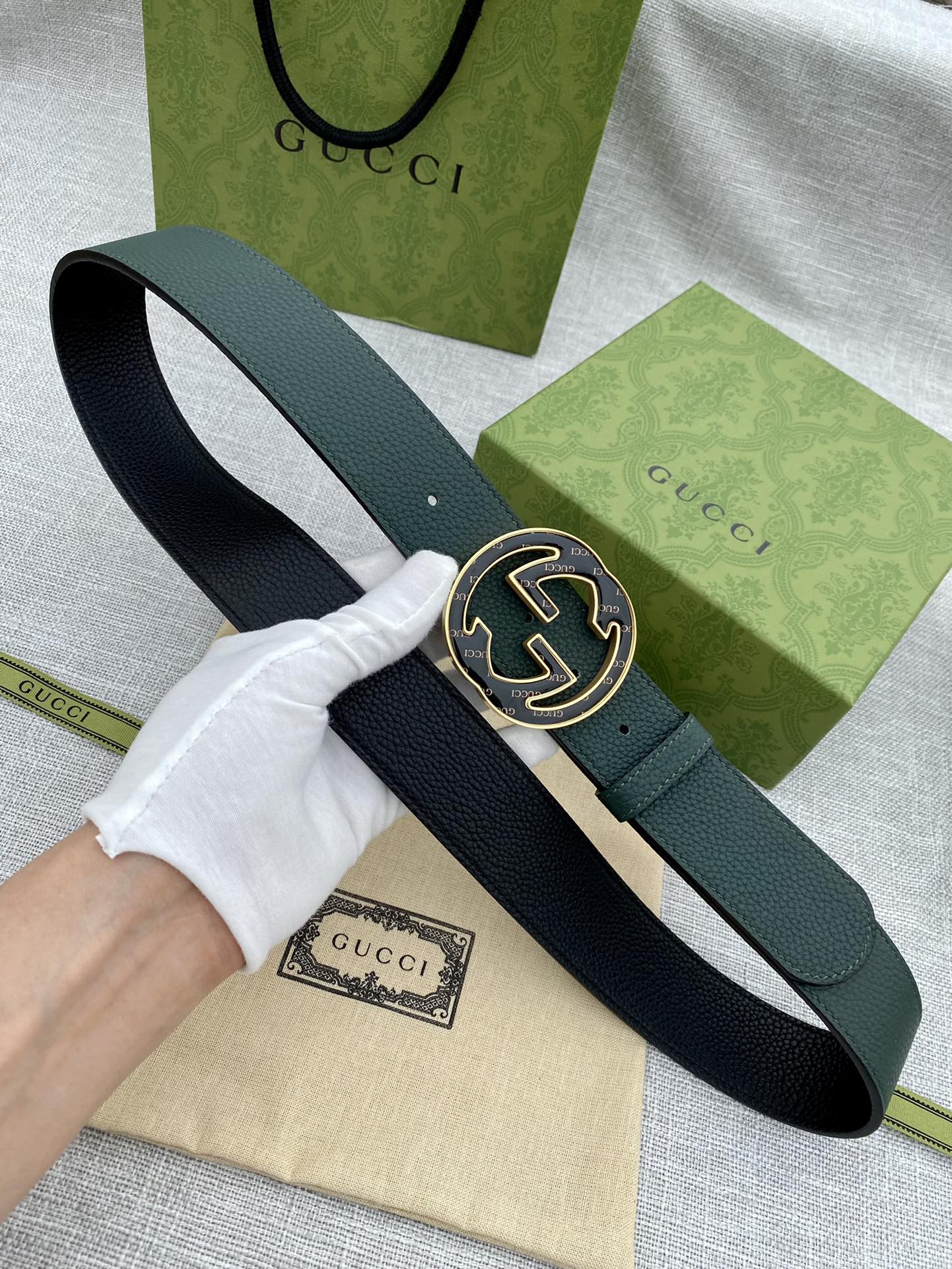 Dark green leather belt with round GG logo buckle, shown on hand for fit