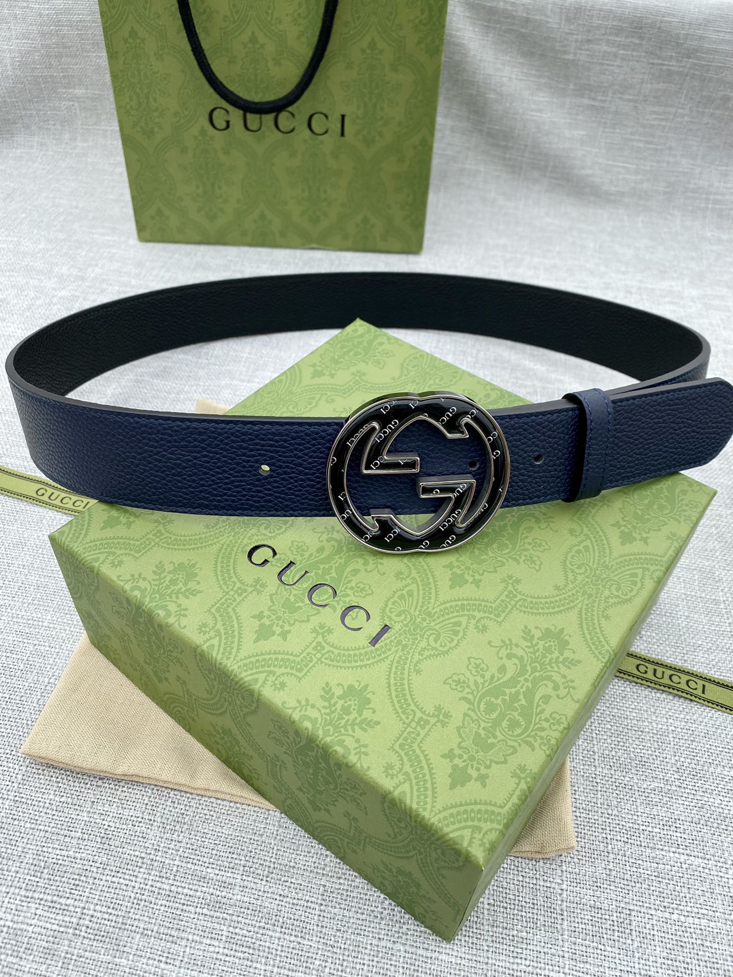 Navy blue leather belt with round double-G logo buckle