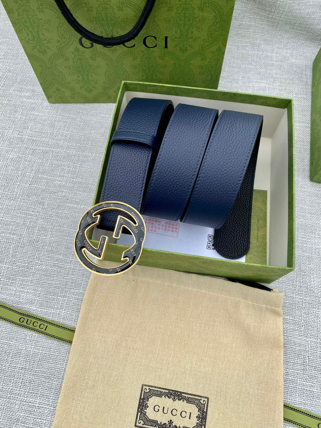 Navy blue leather belt in box with round double-G logo buckle