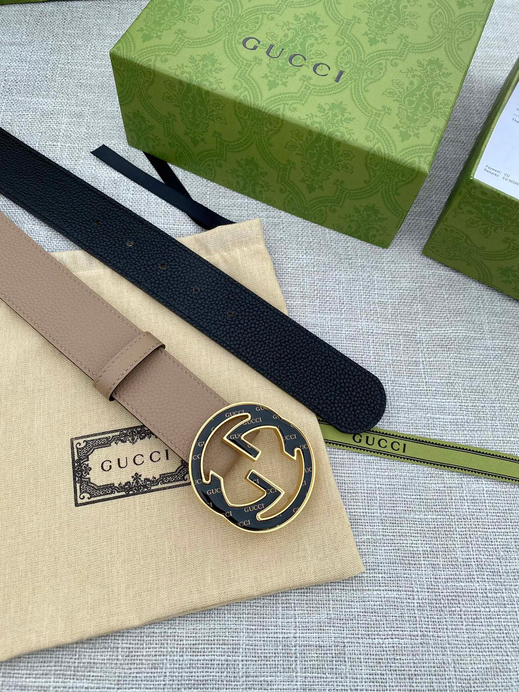 Tan leather belt with circular GG buckle and short keeper strap