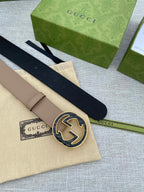 Tan leather belt with circular GG buckle and short keeper strap