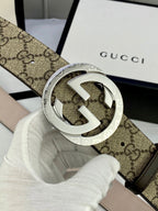 GG canvas belt with silver-tone interlocking G buckle; close-up of buckle detail.