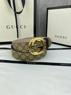 GG canvas belt with gold-tone double G buckle, wide strap in dark brown monogram pattern.