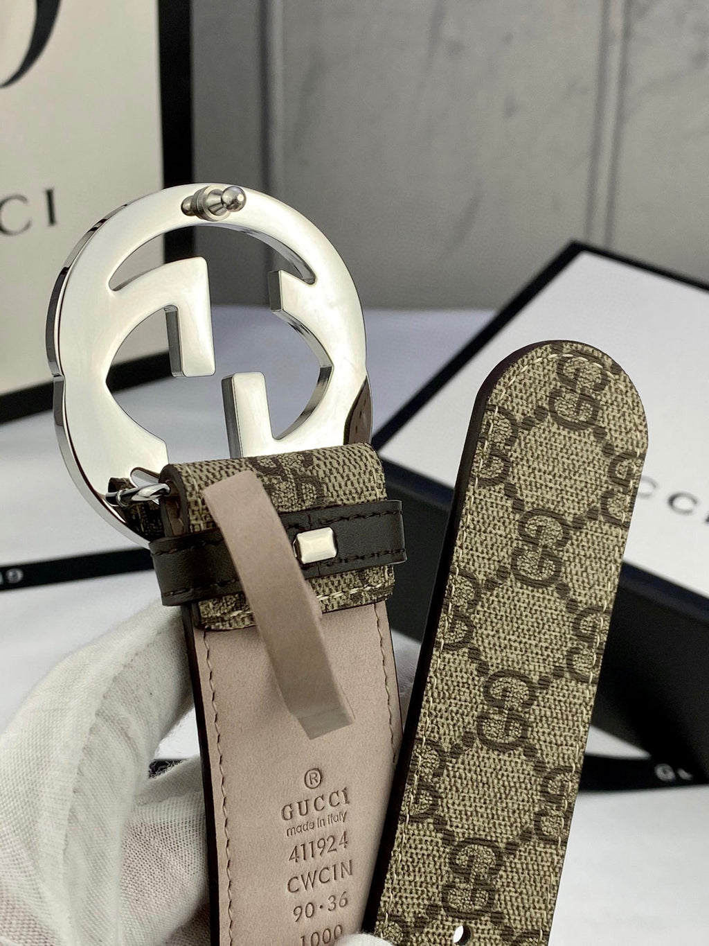 GG canvas belt with large silver-tone double G buckle and beige leather keeper strap.