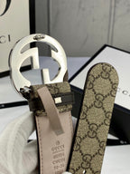 GG canvas belt with large silver-tone double G buckle and beige leather keeper strap.