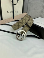 GG canvas belt with silver-tone buckle and beige lining; monogram strap with loop detail.