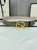 Gucci GG canvas belt with gold-tone double G buckle, light beige strap and monogram print.