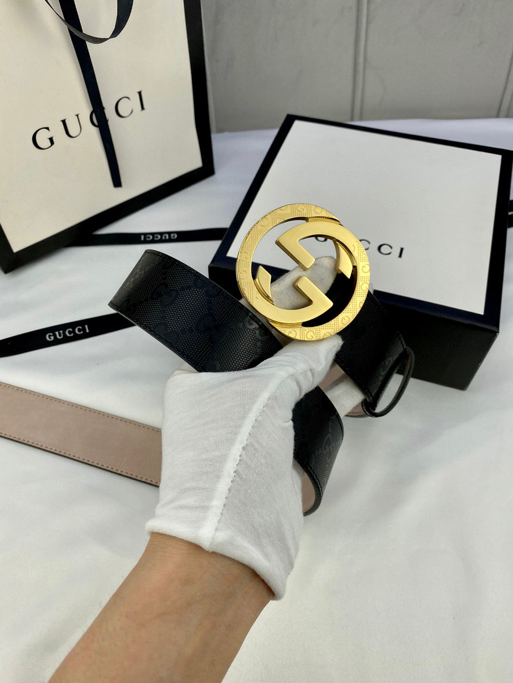Black monogram leather belt with gold double-G buckle and belt end