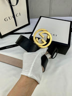 Black monogram leather belt with gold double-G buckle and belt end