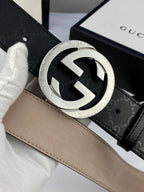 Close-up black monogram belt with silver double-G buckle