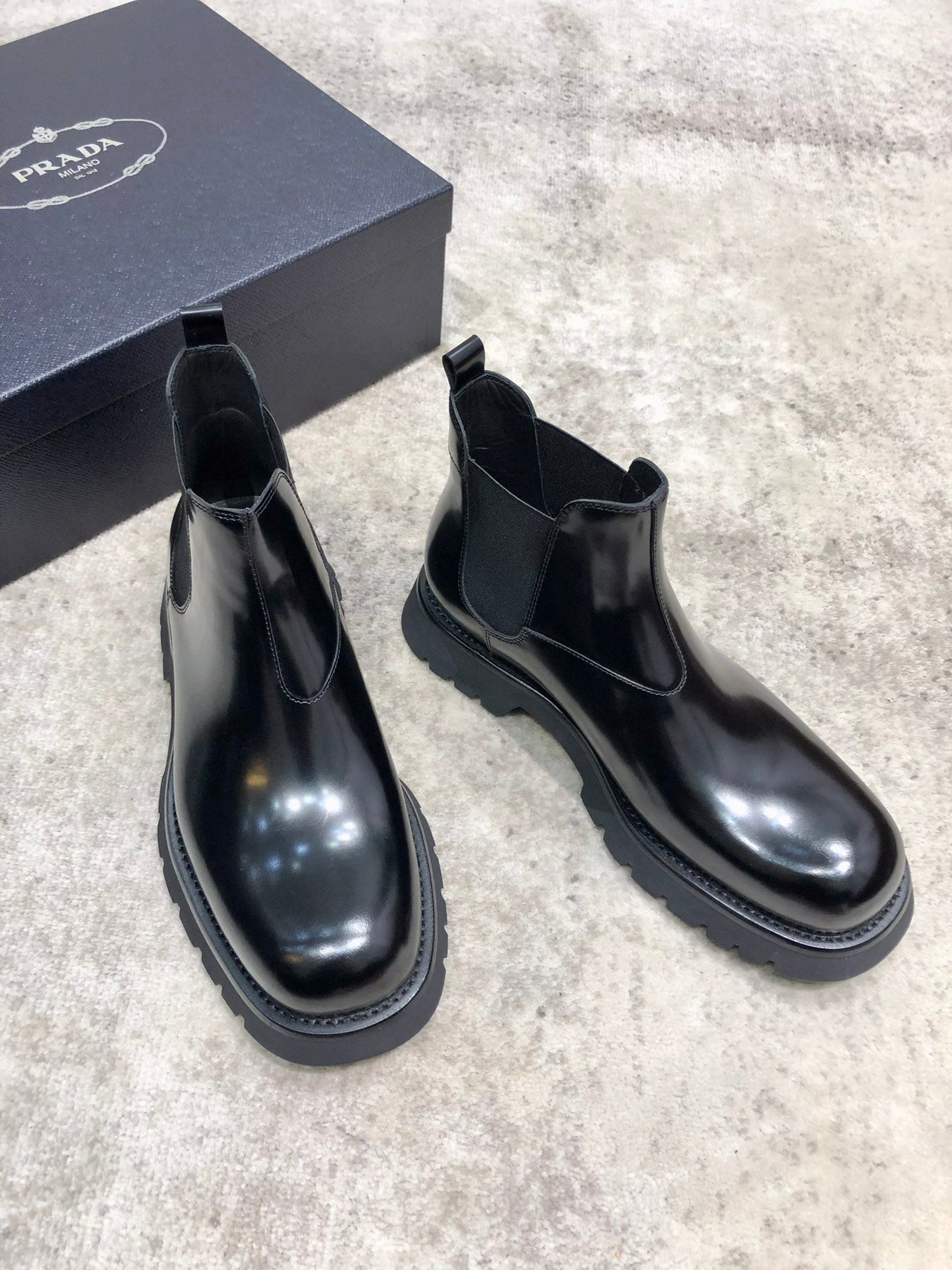 Prada unisex Chelsea boots, dark glossy leather, elastic side panels and rounded toe