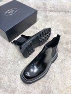 Prada unisex Chelsea boots in dark glossy leather with lug outsole and elastic ankle gore