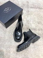 Prada unisex Chelsea boots with dark rubber sole tread and pull-on elastic uppers