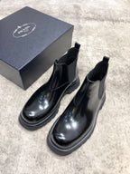 Prada unisex Chelsea boots in dark glossy leather with elastic gore and thick rubber sole