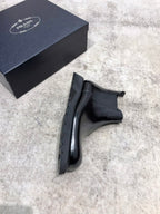 Prada unisex Chelsea boot, dark glossy leather, elastic gore and low stacked heel