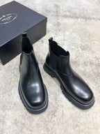 Black leather ankle Chelsea boots with elastic gore and thick treaded outsole