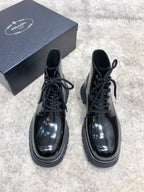 Lace-up leather boots with glossy dark finish, lace-up front, chunky sole
