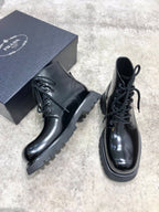 Lace-up leather boots with glossy dark leather, chunky tread sole, lace front