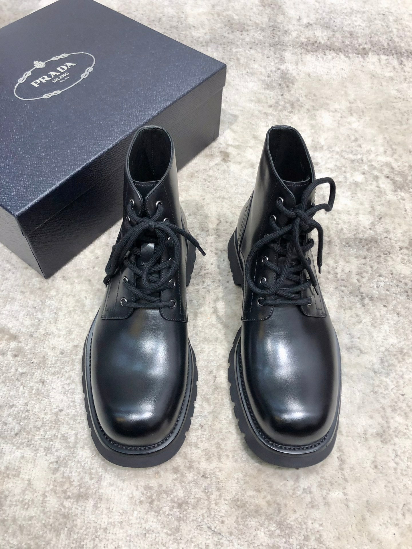 Prada unisex lace-up boots, dark leather, round toe and thick tread sole