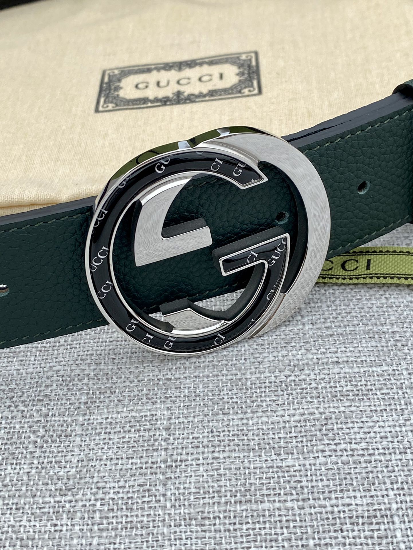 Gucci belt dark green leather with round GG buckle and silver frame