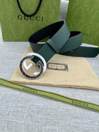 Gucci belt in dark green leather with round silver-and-gold GG buckle