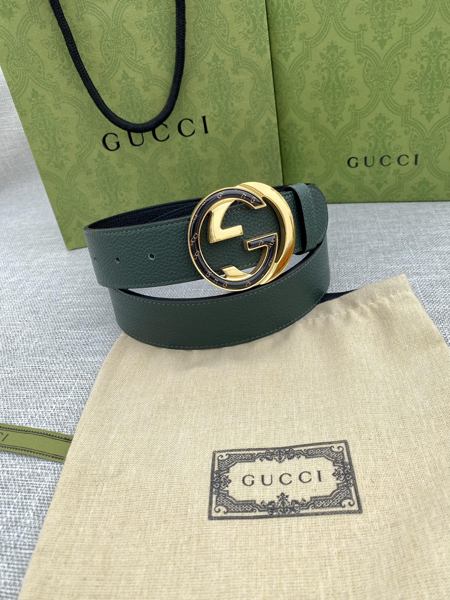Gucci belt dark green leather with round GG logo buckle, gold-tone ring