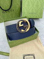 Gucci leather belt with navy strap and gold-tone logo buckle on gift box