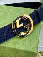 Navy textured leather belt with large gold-tone G buckle detail