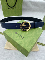 Gucci leather belt with navy strap and gold-tone interlocking G buckle