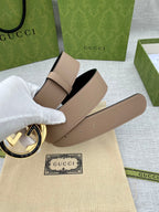 Gucci belt on hand, beige leather strap with gold-toned GG buckle