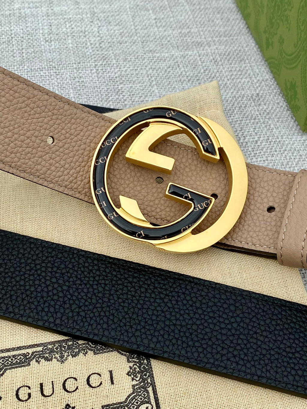 Gucci belt, beige and dark navy straps with gold GG buckle close-up